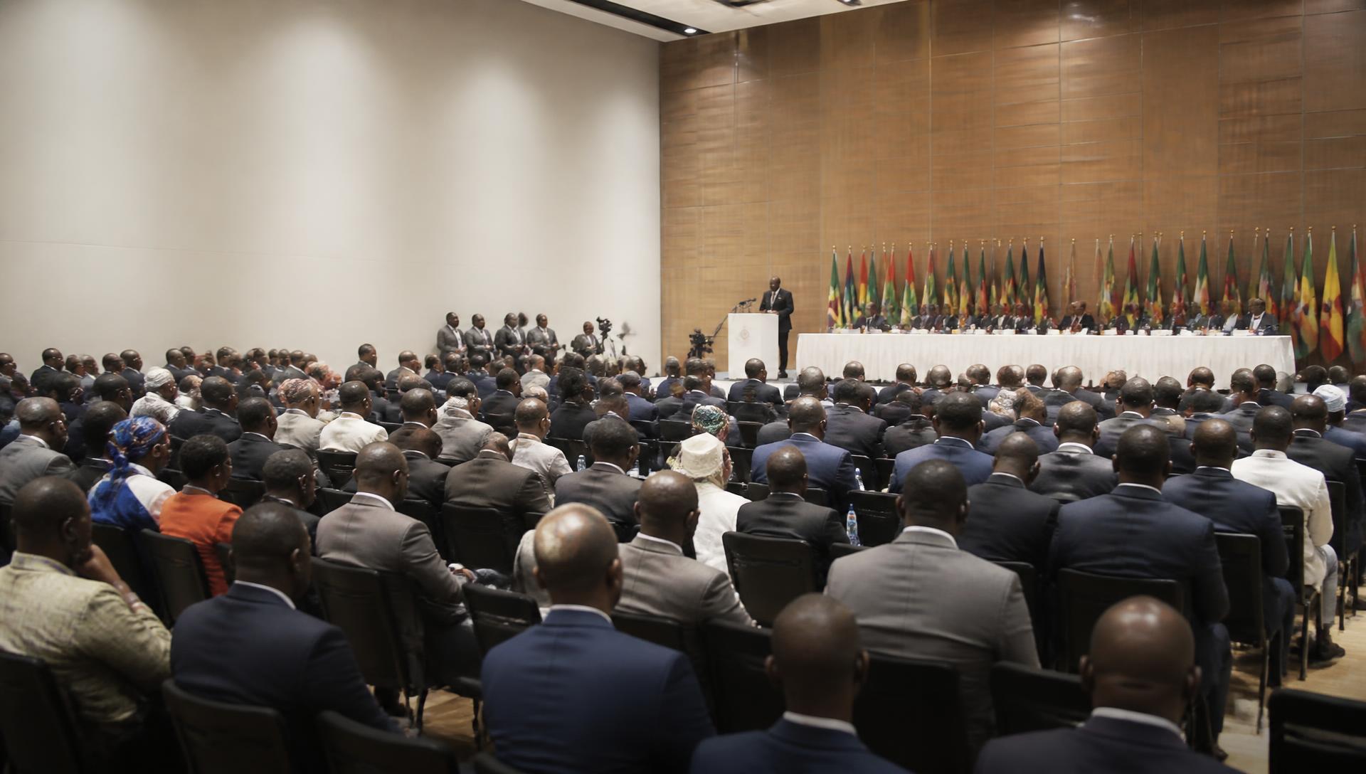 Delegates seated in a plenary session at a policy conference